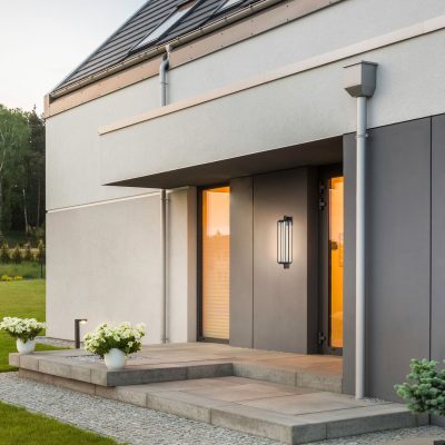 Modern house with simple garden and decorative outdoor lighting